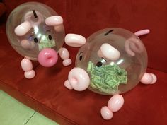 two inflatable pigs with money inside them