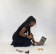 a woman sitting on the floor using a laptop computer