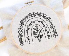 a cross stitch pattern with flowers and a rainbow in the middle on a white background