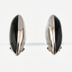 "Beautiful 925 Silver and Black Onyx Almond shaped Minimalist 1-3/8\"L. x. 1/2\" Clip on Earrings. Artisan made in Mexico. Marked GMH Each measures 1-3/8\"L. x 1/2\" at the center. Condition. No damage. Fantastic condition. cosasraras.etsy.com" Modern Black Sterling Silver Earrings, Classic Sterling Silver Earrings With Black Enamel, Classic Black Enamel Sterling Silver Earrings, Modern Silver Earrings With Black Enamel, Silver Onyx Earrings For Formal Occasions, Modernist Black Earrings As Gift, Modernist Black Earrings For Gift, Vintage Clip, Black Onyx