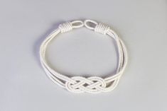 a white rope bracelet on a gray background