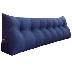 a blue pillow with buttons on the front and back side, sitting against a white background