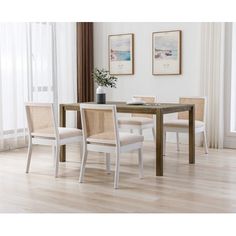 a dining room table with four chairs around it