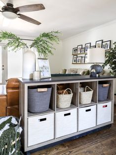 a living room filled with furniture and baskets