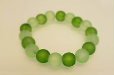 High quality cute beaded bracelet! Elastic string and glass beads. There are two sizes, 6 inches, and 7 inches. Our processing time is 1-4 days. Your package will arrive in your mailbox. This is our kiwi/seaweed inspired bracelet. These two shades of green look really nice together. My name is Yvette and I'm a teen entrepreneur, I hand-make all three of these bracelets. Please CAREFULLY choose your size because there are no returns, refunds, or exchanges. Check out our other beaded bracelets: https://www.etsy.com/shop/shopsistersnook?section_id=41511611 Bracelet Cute, Green Bracelet, St. Patricks Day, Aesthetic Green, Green Shades, Glass Beaded Bracelets, Cute Bracelets, Saint Patrick, Green Design