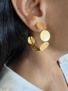 For all hoop lovers, One of a kind designer piece by SHIVKA. Simply Stylish and Elegant! A gorgeous pair of hoop studs. Purely handmade with love by our skilled Indian craftsmen from Jaipur  Handcrafted in brass with a textured gold-plated base. This designer jewelry piece can go well with both Indian and western wear. Dimensions: Weight per Pair: 16 grams Drop Length: 4 cm Width:  3.5 cm Closure Type: Push Back Closure Elegant Handmade Semi-circle Earrings, Unique Handmade Hoop Earrings For Wedding, Modern Handmade Hoop Earrings For Anniversary, Elegant Handmade Circular Hoop Earrings, Handmade Modern Hoop Earrings For Anniversary, Elegant Handmade Hoop Earrings, Handmade Hoop Earrings For Anniversary, Gold Texture, Jewelry Earrings Hoops