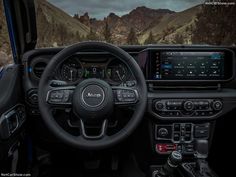 the interior of a jeep with mountains in the background