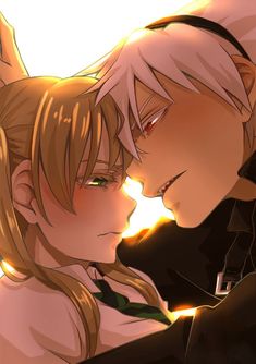 two anime characters are kissing each other in front of an orange light and the background is blurry