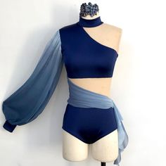 a female mannequin wearing a blue top and shorts with sheer sleeves on it