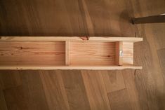 a wooden shelf sitting on top of a hard wood floor