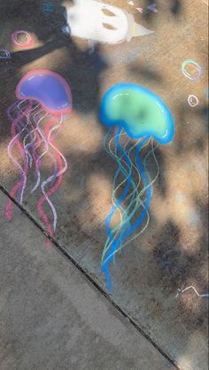 colorful jellyfish chalk drawings on the sidewalk