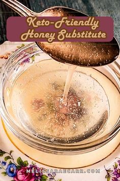 a spoon pouring honey into a glass jar with the words keto - friendly honey substance