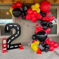 balloons and streamers decorate the entrance to a race themed birthday party