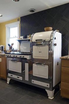 an old fashioned stove and oven in a kitchen