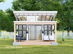 the tiny house is built in the middle of a grassy area with two couches