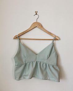 Hand made peplum tank top in Mint. This specific tank top has been made with thrifted fabric so It is sustainable and ethically made.  This Tank top fits S/M Cotton Ruffle Cami Tank Top, Summer Cotton Peplum Top, Cotton Ruffled Tank Top, Cotton Ruffle Camisole Top, Fitted Cotton Peplum Top For Summer, Chic Sleeveless Cotton Peplum Top, Cotton Peplum Tops, Fitted Peplum Tank Top For Spring, Tank Top Fits