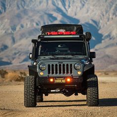 a jeep with its lights on in the desert