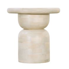 a white marble vase with a circular top on it's side, against a white background