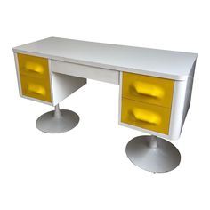 a white desk with two yellow drawers on each side and silver pedestals at the bottom