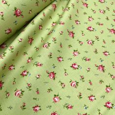 a green fabric with pink flowers on it