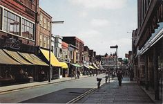 a city street with people walking down it