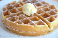 a waffle topped with butter on top of a white plate