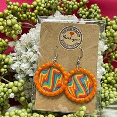 a pair of colorful earrings sitting on top of a package