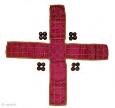 a cross made out of fabric with buttons on it