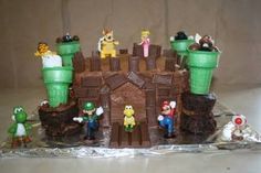 a cake made to look like mario and luigi's castle with other characters on it