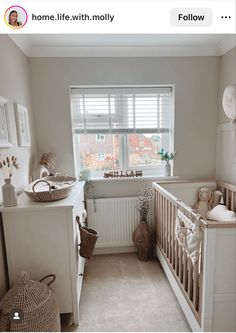 a baby's room with a crib and window