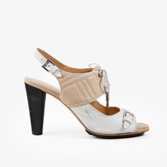 Perfect For A Summer's Night Out, These Sandals From Tod's Features A Features A Sophisticated Design That Combines Style And Comfort. The Shoe Boasts A Mix Of Beige And White Leather, Creating A Chic, Two-Tone Effect. The Upper Part Includes Detailed Stitching, Adding A Touch Of Refinement. A Lace-Up Front With Silver-Tone Aglets And A Matching Silver Buckle On The Toe Strap Enhances The Overall Aesthetic. The Adjustable Ankle Strap Ensures A Secure Fit, While The High Cone Heel Adds A Touch Of Sophistication, Making These Sandals Perfect For Both Casual And Formal Occasions. Size: 41 It Condition: Good; Marks, Scuffs, And Creasing Present Throughout Both Heels On The Upper, Insole, And O Designer Slingback Sandals With Padded Heel For Summer, Designer Summer Slingback Sandals With Padded Heel, White Open Toe Heels With Leather Sole, White Leather Slingback Sandals For Party, Modern White Slingback Sandals With Padded Heel, Modern White High Heel Slingback Sandals, White Open Heel Heels With Leather Sole, Designer High Heel Slingback Sandals For Summer, Designer Spring Slingback Sandals With High Heel