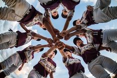 a group of people standing in a circle holding hands