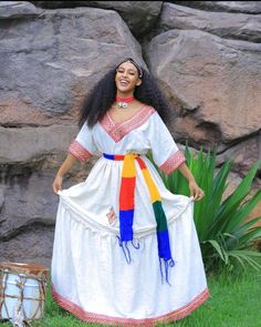 Experience the vibrant celebration of Ashenda with our beautiful Ethiopian and Eritrean cultural festive dress. This stunning ensemble features traditional patterns and rich colors, embodying the spirit of this joyous occasion. Complete your look with our carefully curated accessories, including elegant jewelry and headpieces, to capture the true essence of Ashenda. Whether you're participating in the festivities or simply appreciating the rich cultural heritage, this outfit is perfect for showcasing the beauty and tradition of the event. Ceremonial Dresses With Embroidered Border For Festivals, Dress With Woven Motifs For Cultural Festivals, Folk Style Dress With Traditional Drape For Festivals, Festival White Habesha Kemis With Woven Motifs, White Habesha Kemis With Woven Motifs For Festivals, Folk Style Dress With Embroidered Border For Festivals, Folk Dresses With Embroidered Border For Festivals, Festive Habesha Kemis For Traditional Ceremonies, Navratri Dress With Embroidered Border