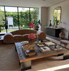 a living room filled with furniture and large windows