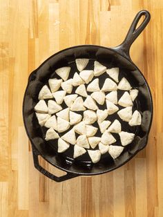 a pan filled with cut up food on top of a wooden table