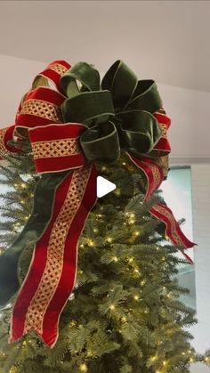 a christmas tree decorated with red and green ribbons