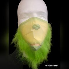 a green and white mask with long hair