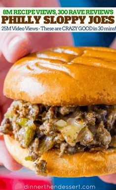 a close up of a person holding a sandwich with meat and vegetables on it in their hand