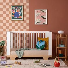 a child's bed with toys on the floor next to it in a room