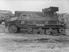 an old tank is parked in the dirt