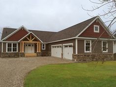 a brown house with two garages on the side