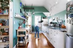 a blurry image of a person in the kitchen looking at something on the counter