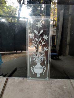 an etched glass vase with flowers in it