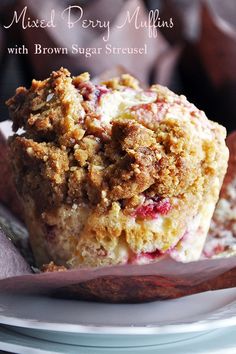 two muffins sitting on top of a white plate covered in crumbs