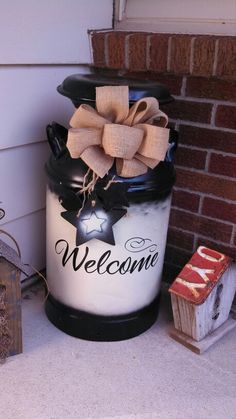 a welcome container with a bow on the top and ribbon tied to it's side