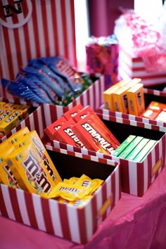 candy boxes are lined up on a table