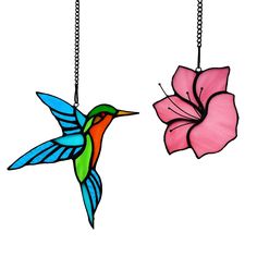 two stained glass hummingbirds and a pink flower hanging from chains on a white background