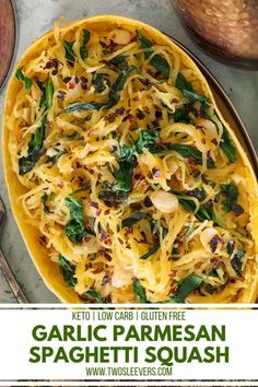 garlic parmesan spaghetti in a yellow dish with spinach and cheese on top