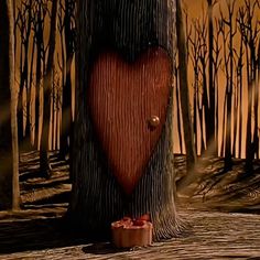 a heart shaped hole in the bark of a tree with a candle on it, surrounded by dead trees