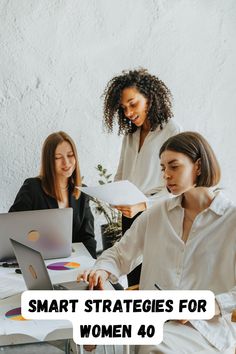 three women sitting at a table working on laptops with the words smart strategy for women 40